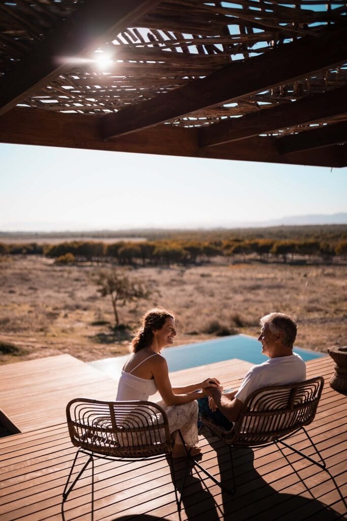 senior couple sitting on chairs at the resort hnscyfx.jpg