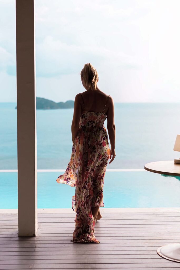 woman in flying summer dress at luxury hotel villa m6j8vzt.jpg